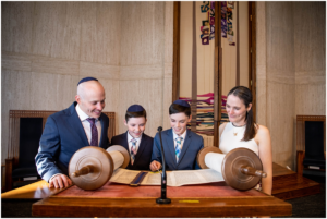 A family looks at the Torah