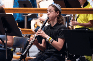 Rak Noar Teen Playing Clarinet at Chanukah 2023