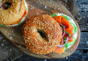 Vegan smoked salmon (carrot lox) bagel with cream cheese, capers, and cucumber. Healthy food concept. Top view