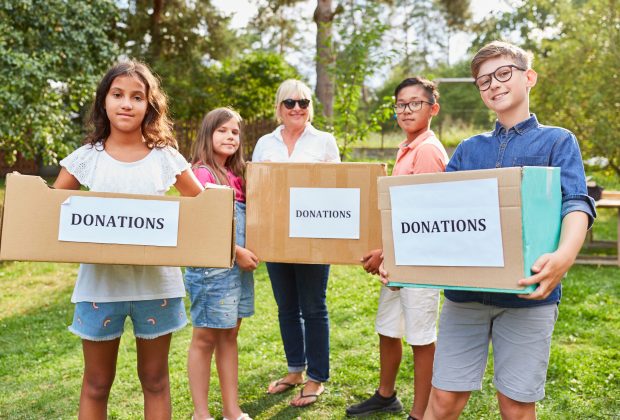 Children as voluntary helpers collecting donations for clothing collection